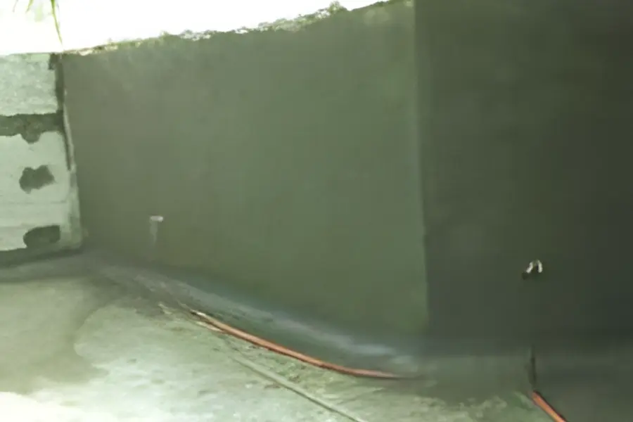 A tank wall in cementitious waterproofing